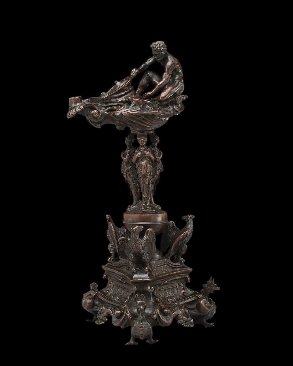 A bronze figure representing talent being lifted into institutional form